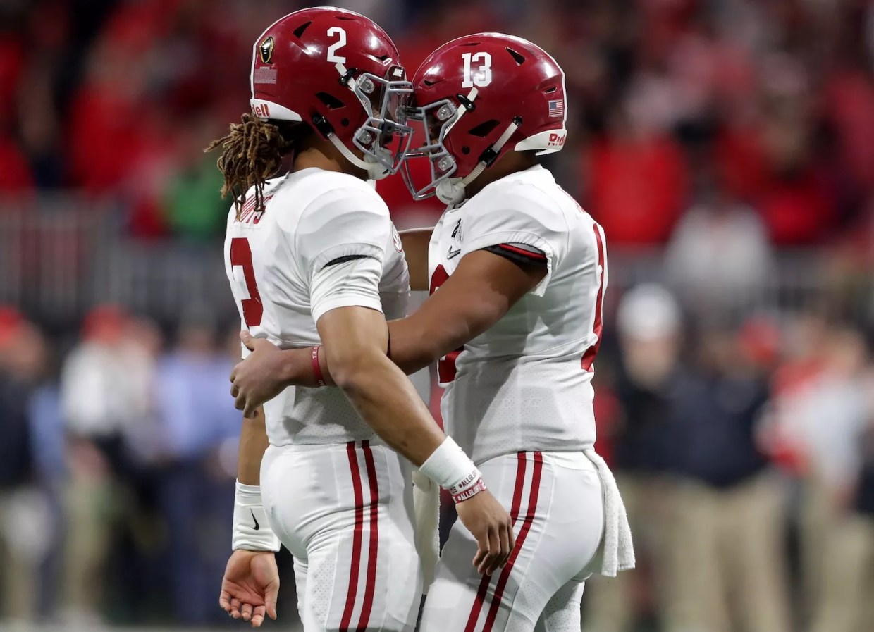 ua Tagovailoa #13 celebrates with Jalen Hurts #2 of the Alabama Crimson Tide during the third quarter against the Georgia Bulldogs in the CFP National Championship at Mercedes-Benz Stadium in Atlanta, Georgia, on January 8, 2018.