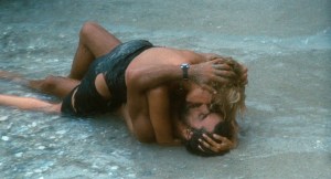 film still from 1974's Swept Away, featuring Raffaella and Gennarino passionately kissing on the beach