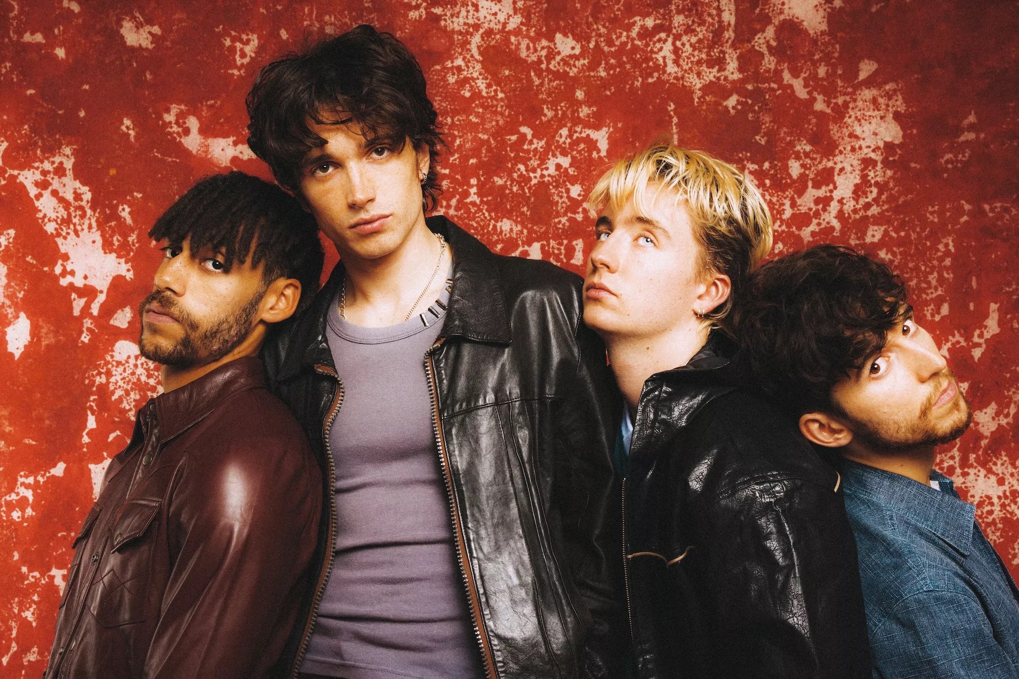 Portrait of the members of Inhaler against a red background