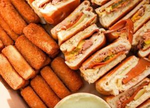 a variety of fried pastries and sandwiches