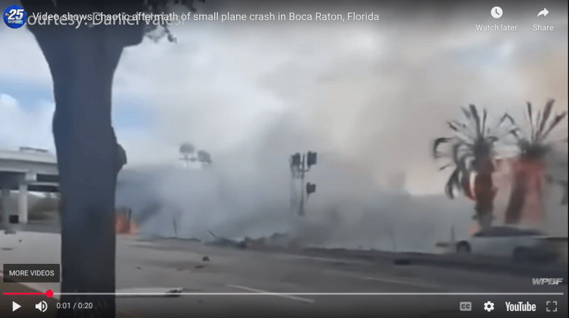 A plane crash causes debris to smoke and scatter across a roadway