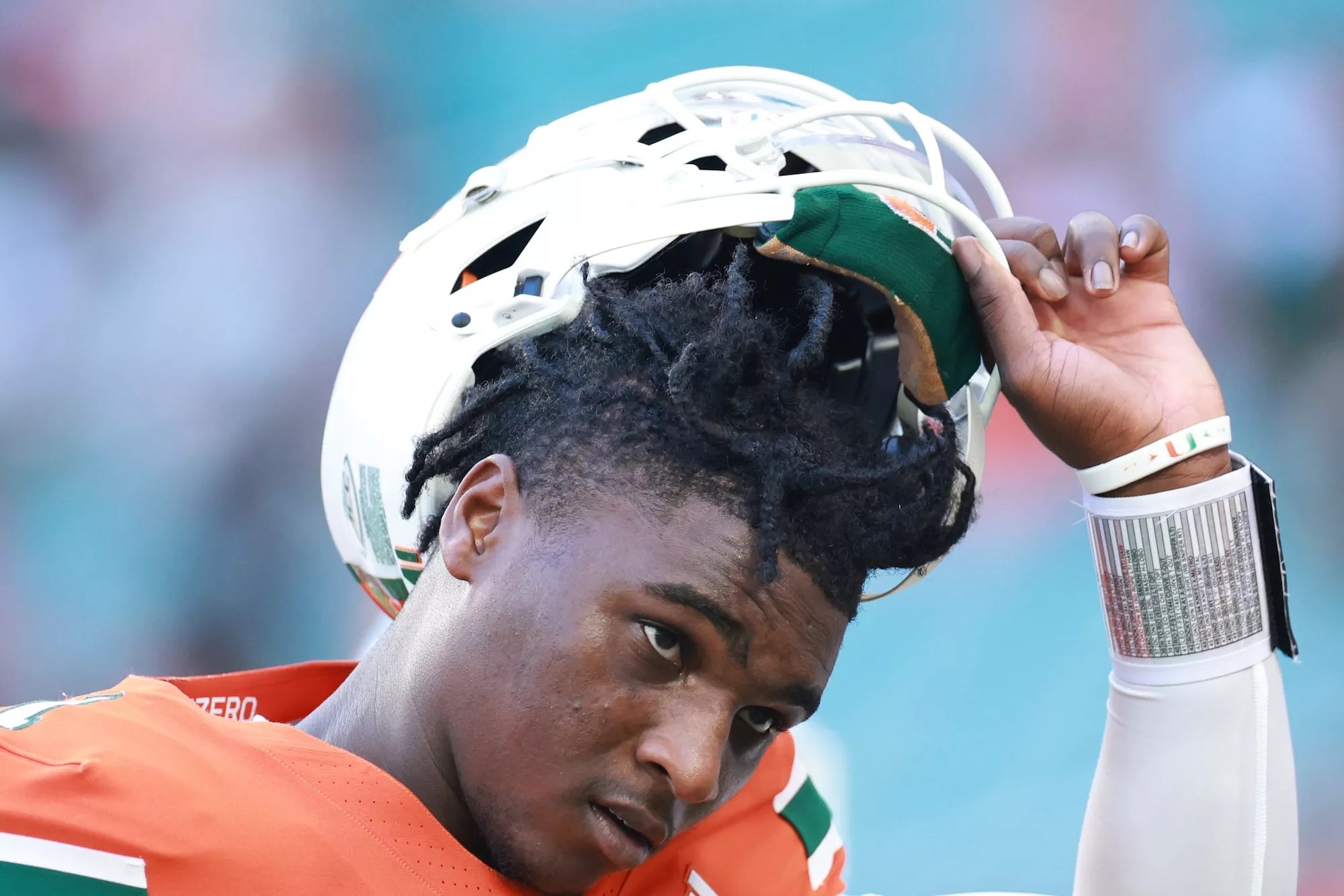 Quarterback Cam Ward #1 of the Miami Hurricanes, looking determined with his helmet tilted back to show his face as he prepares to face Florida A&M Rattlers at Hard Rock Stadium on September 07, 2024