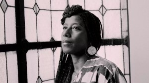 a sepia-toned headshot of poet Aja Monet