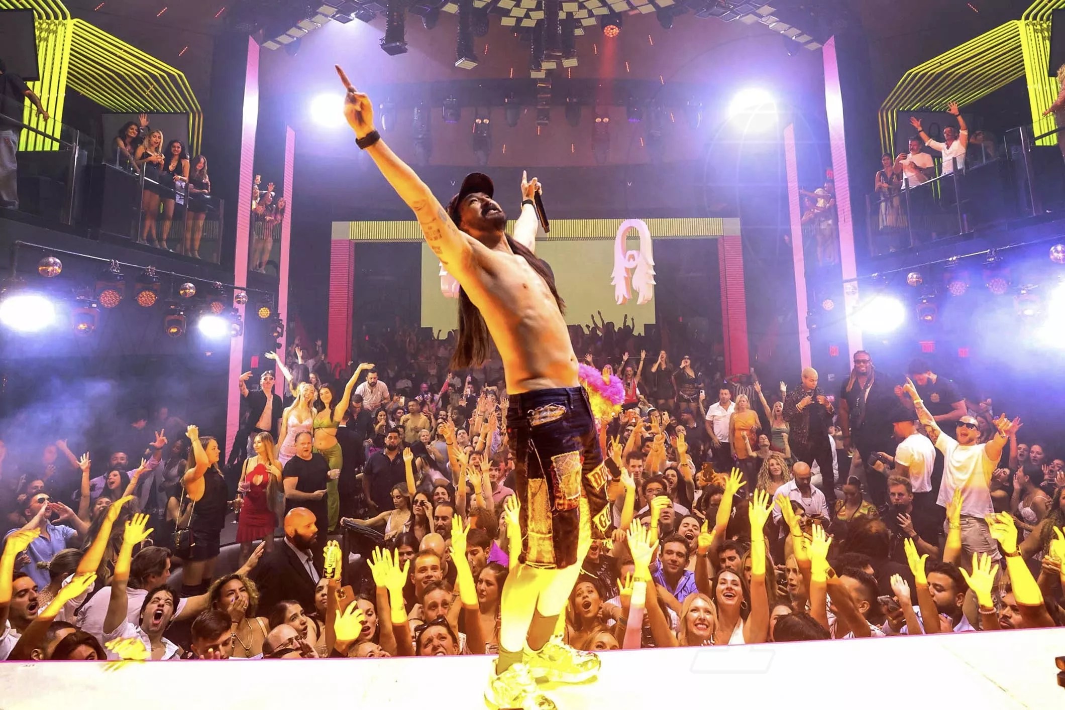Picture of steve Aoki on stage in front of a crowd