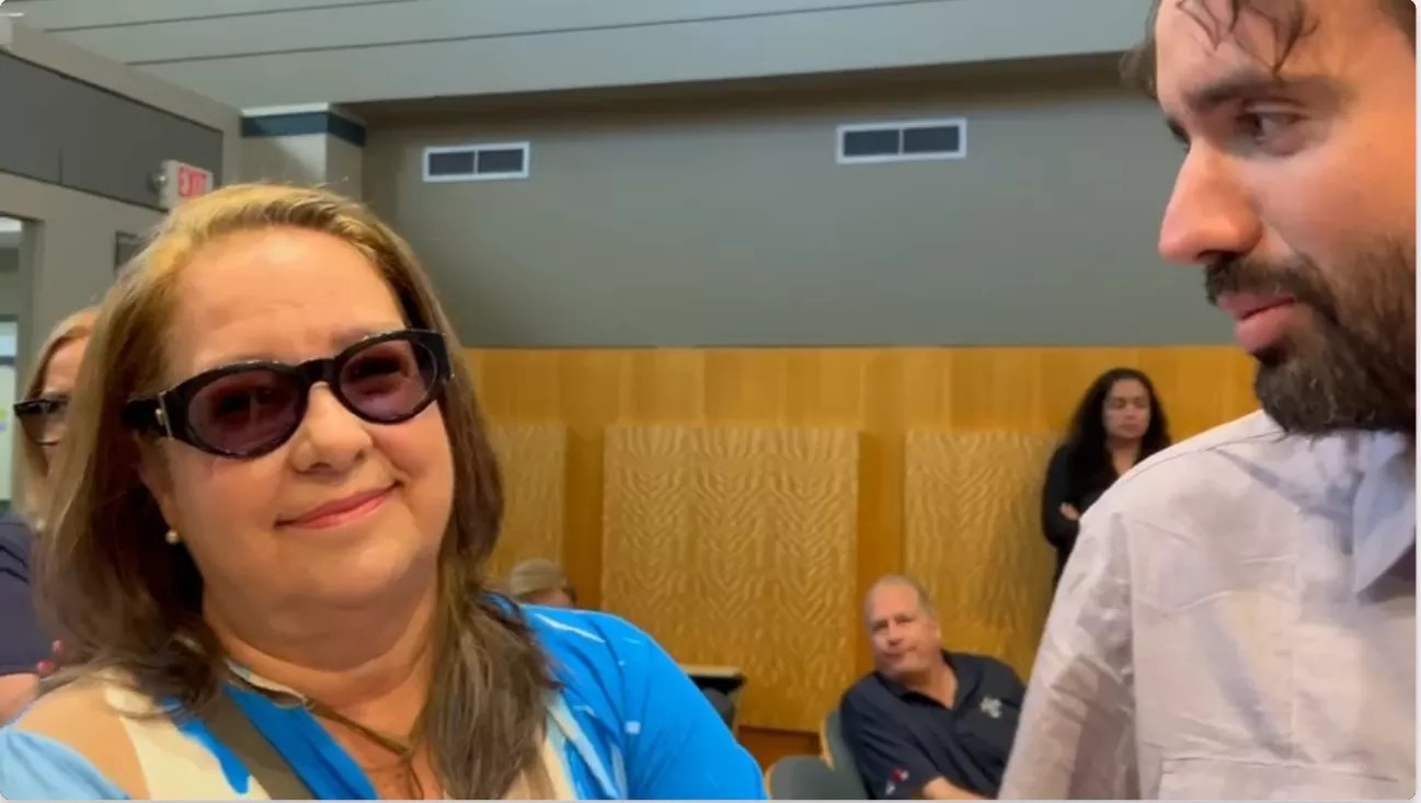 Beba Sardiña Mann looks at the camera next to Thomas Kennedy