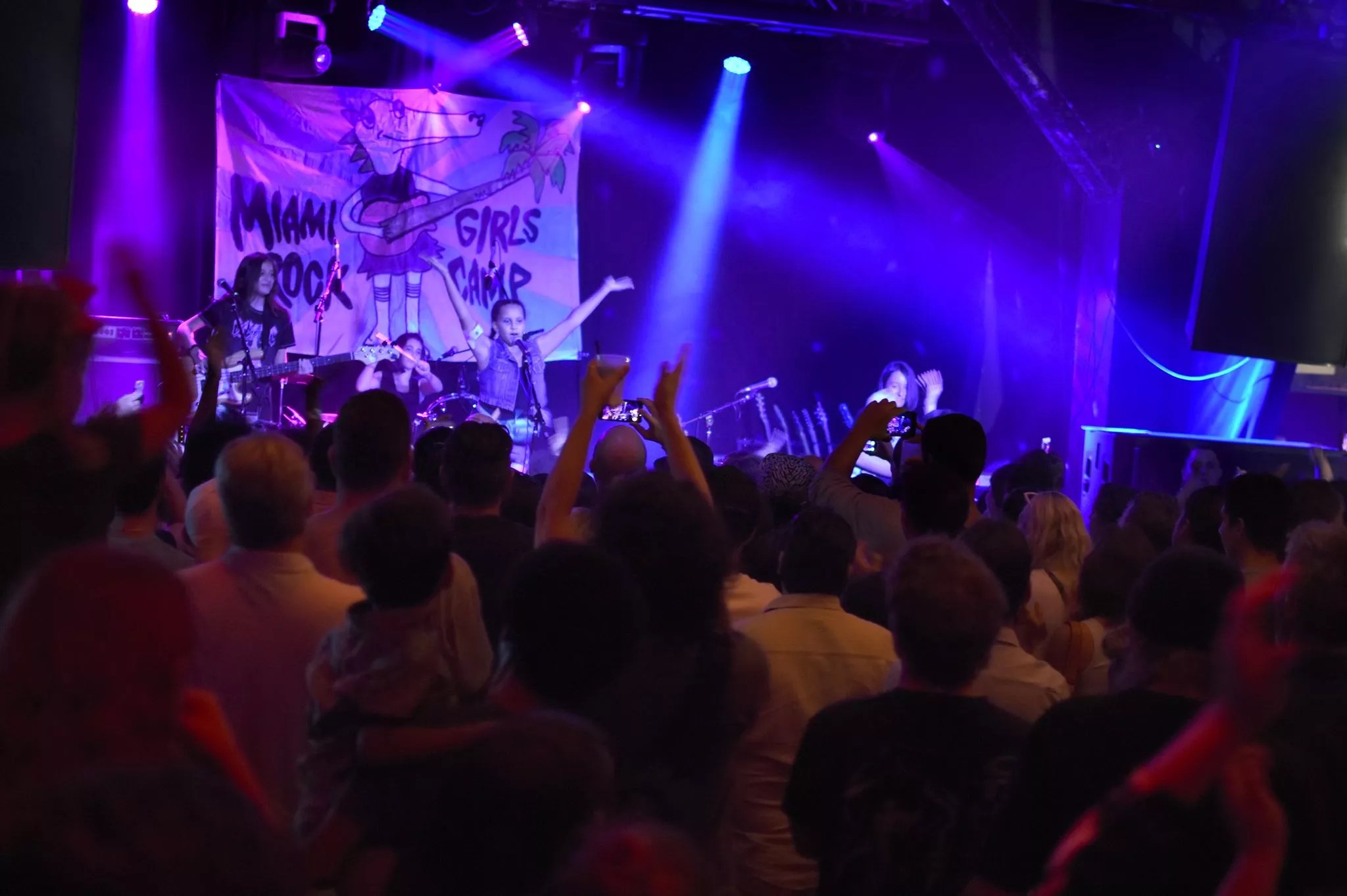 A young band performing in front of a crowd.