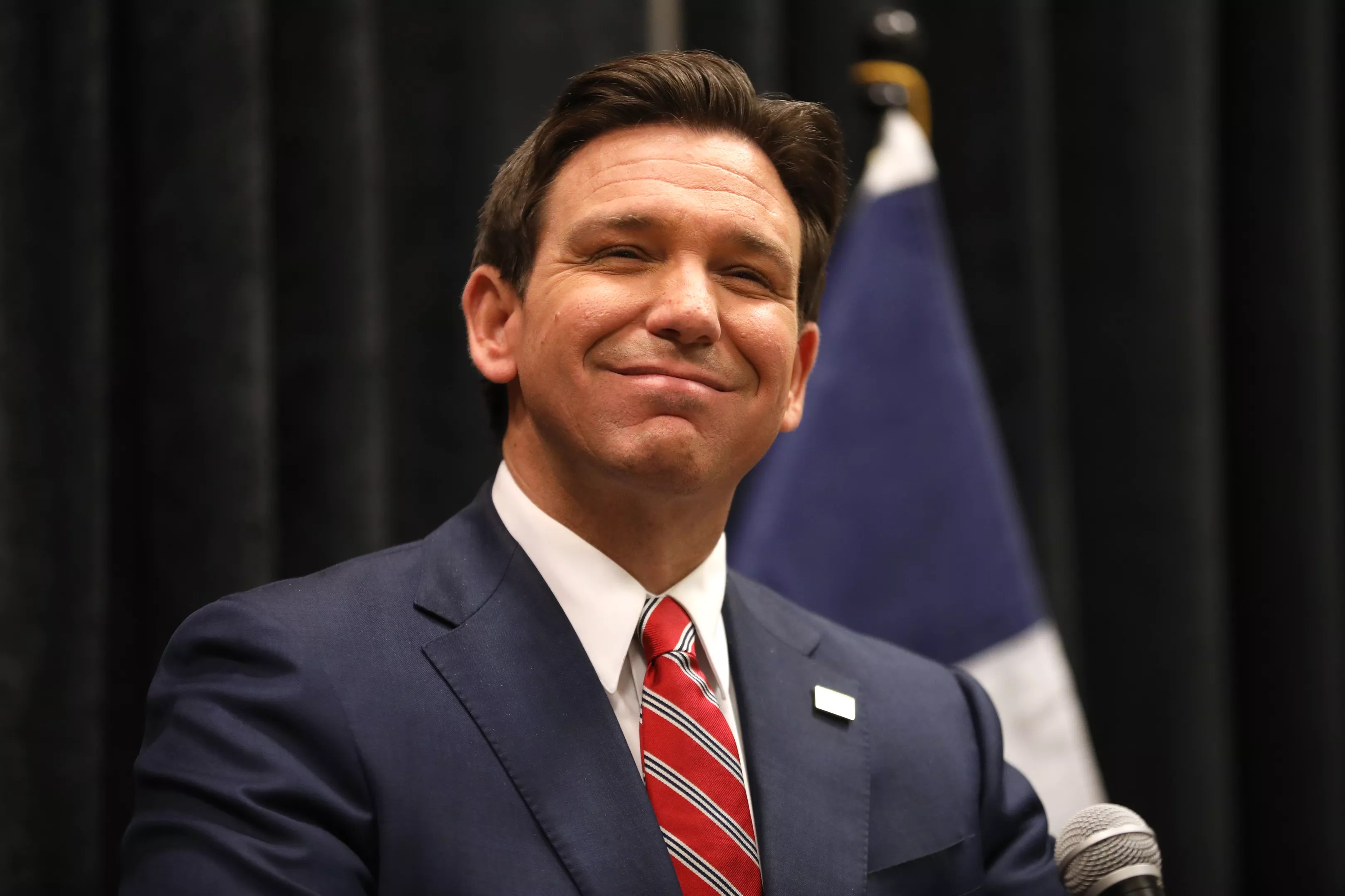 Florida Governor Ron DeSantis smiles for photographers.