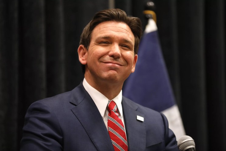 Florida Governor Ron DeSantis smiles for photographers.