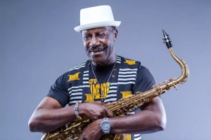 Picture of a black man holding a saxophone.