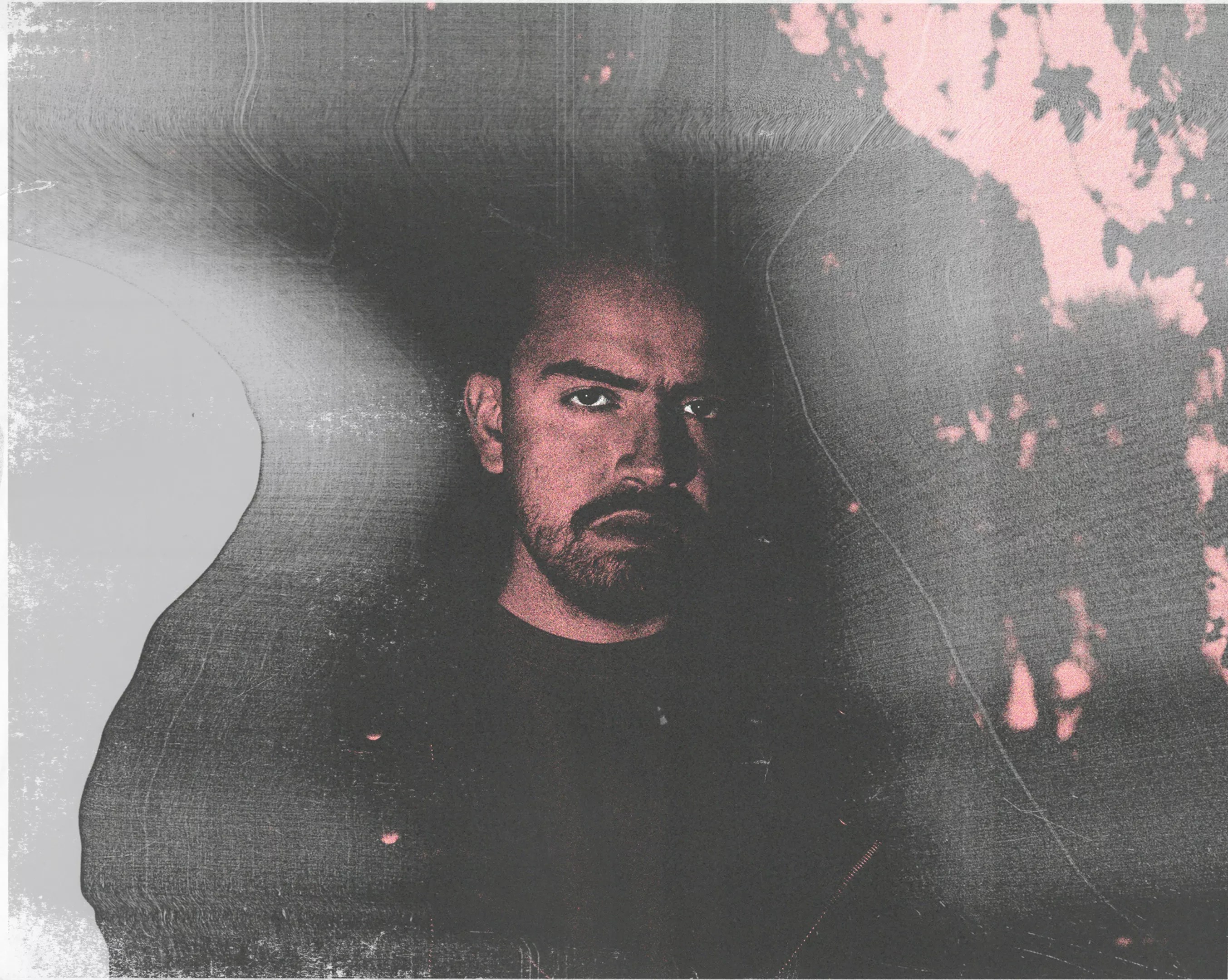 Portrait of a man against a black and pink backround