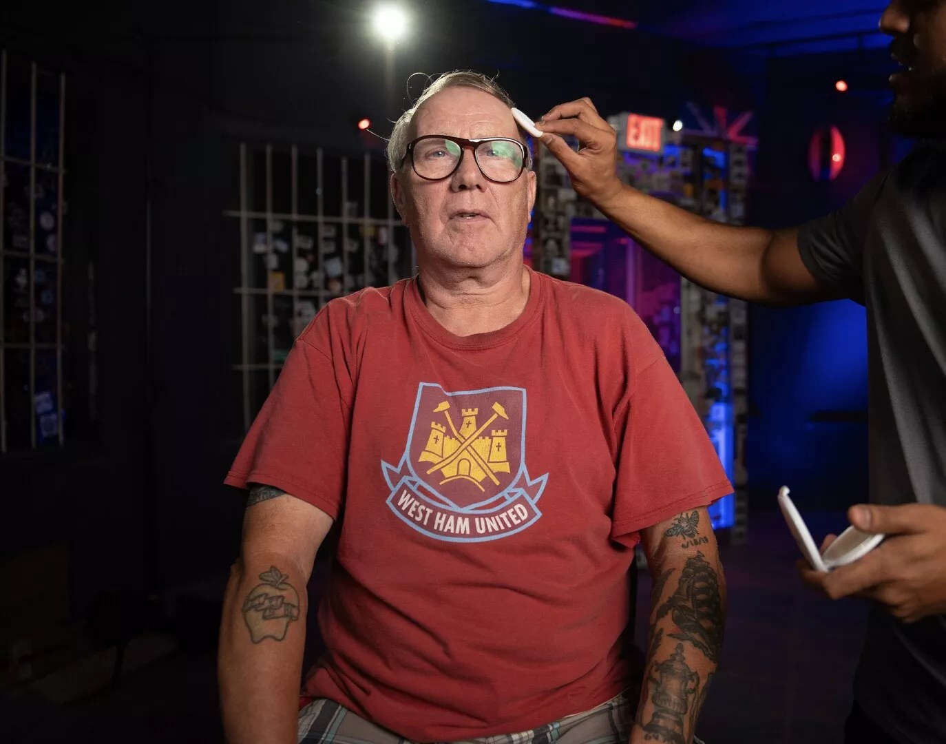 film crew preps a man for a video shoot