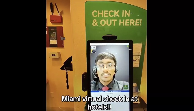 A remote receptionist talks with a guest at a Miami hotel.