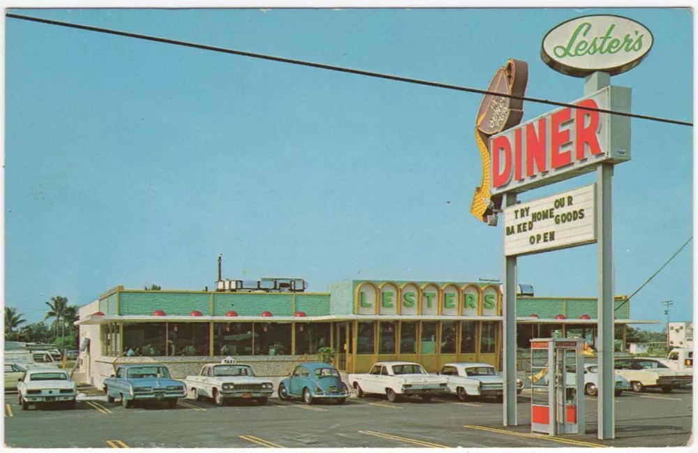 a vintage photograph of a diner with cars parked out front in the parking lot from the 1960s or 1970s