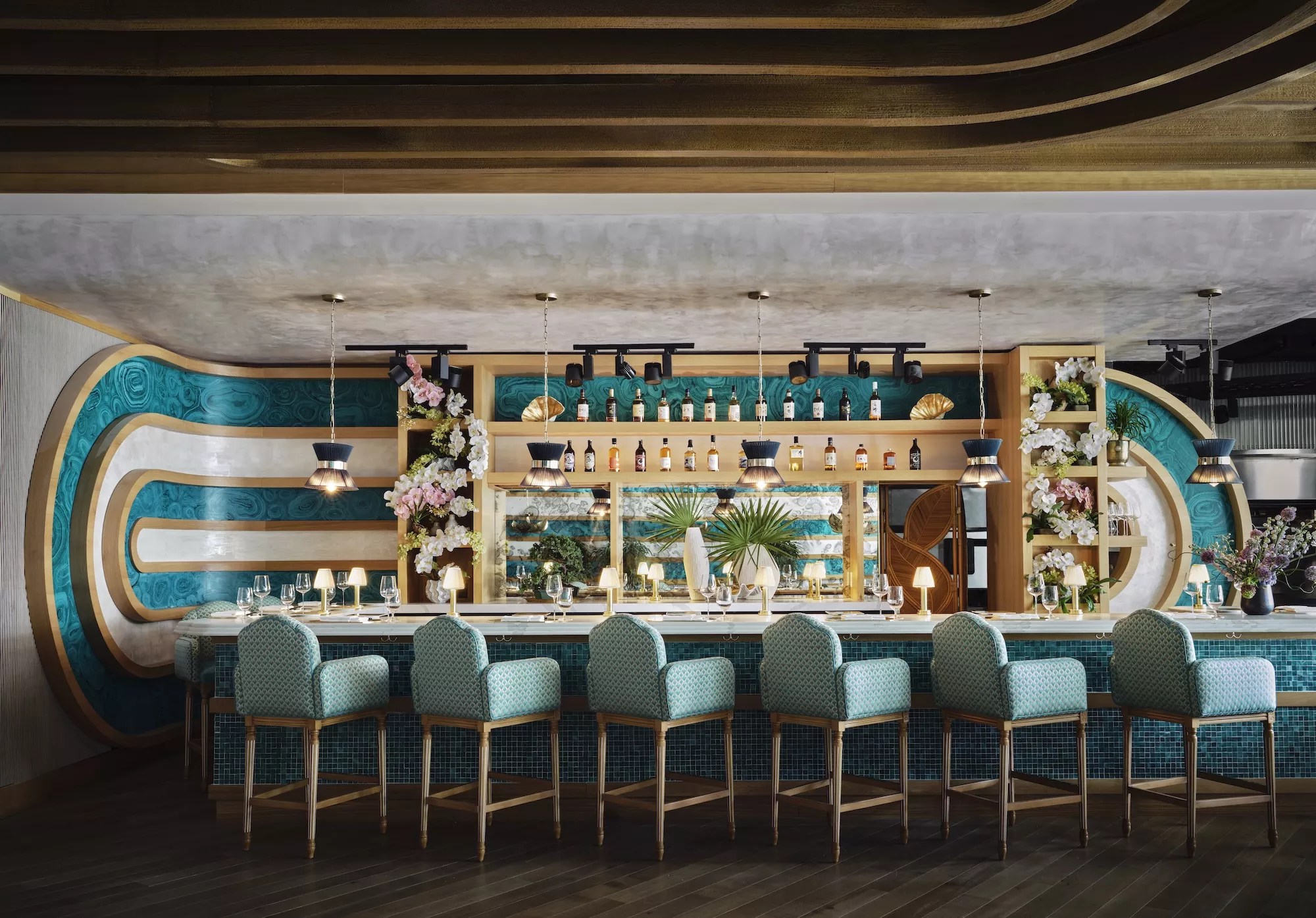 a midcentury style bar with six plush chairs