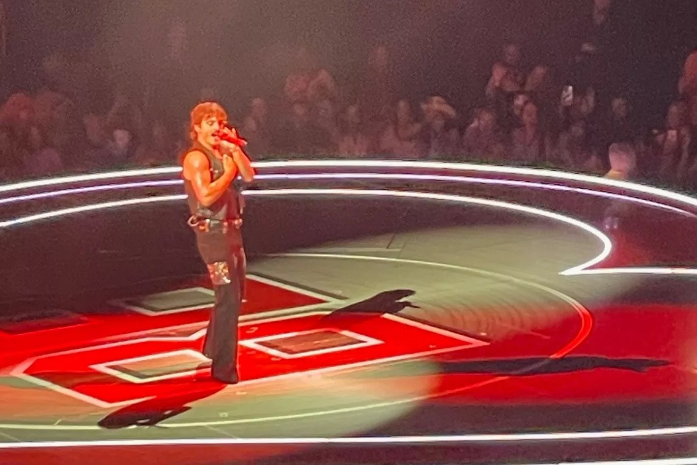 Picture of Benson Boone on stage in Miami singing during a concert.